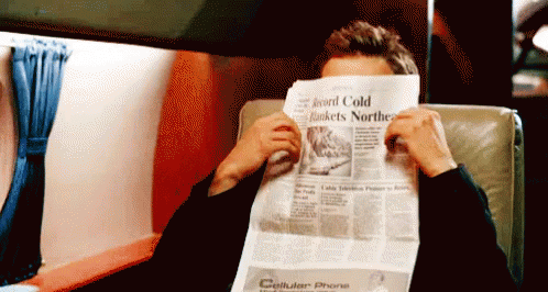 A Man Covering His Face With A Newspaper That Says Cellular Phone GIF