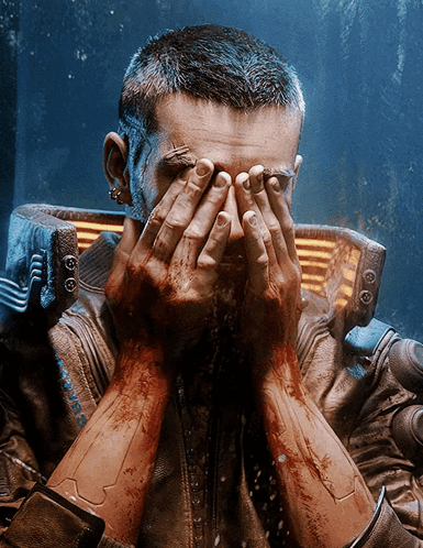 A Man Covering His Face With His Hands While Wearing A Jacket That Says Cyberpunk On It GIF