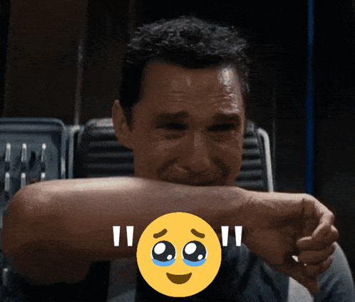 A Man Covering His Mouth With His Hand And A Smiley Face With Tears On It GIF