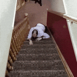 A Man Crawling Down A Set Of Stairs With A Railing GIF