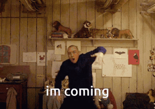 a man dancing in a room with the words im coming