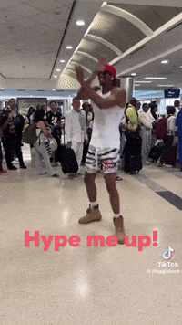 A Man Dancing In An Airport With The Words Hype Me Up GIF
