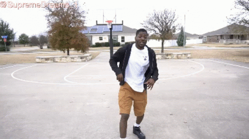 A Man Dancing On A Basketball Court With Supreme Dreams Written On The Bottom Right GIF