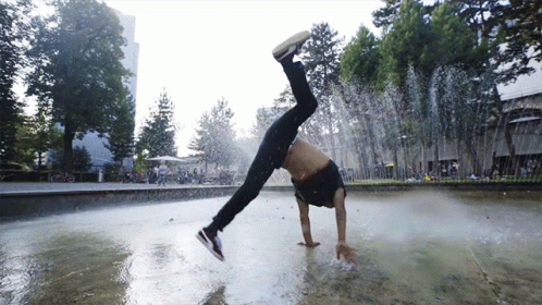 A Man Does A Handstand In A Fountain GIF