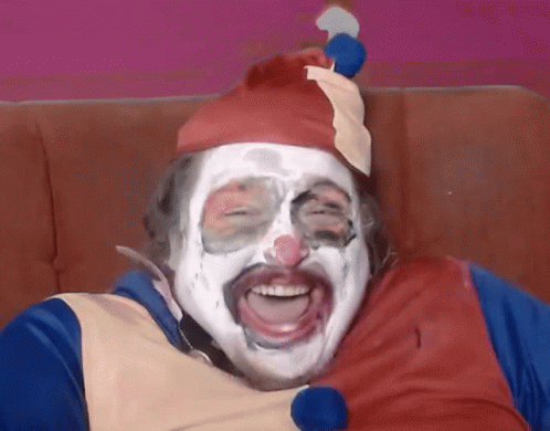 A Man Dressed As A Clown With White Paint On His Face GIF