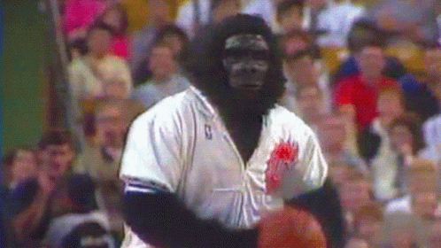 A Man Dressed As A Gorilla Holding A Basketball GIF