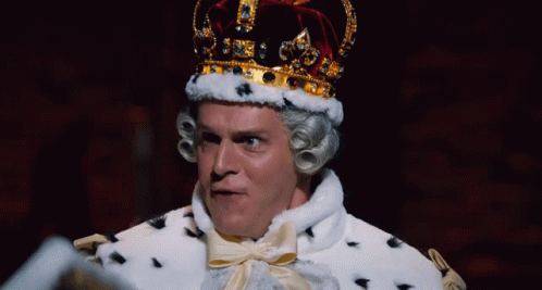 A Man Dressed As A King With A Crown On Top Of His Head GIF