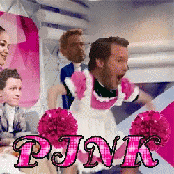A Man Dressed As A Maid Is Surrounded By Pink Cheerleaders GIF