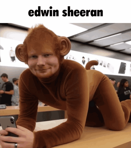 A Man Dressed As A Monkey Is Holding A Cell Phone GIF