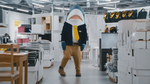 a man dressed as a shark in a store