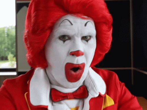 A Man Dressed As Mcdonald 'S Ronald Mcdonald With A Surprised Look On His Face GIF