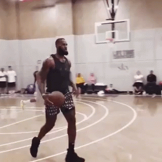 A Man Dribbles A Basketball On A Court With The Word Nike On His Shorts GIF
