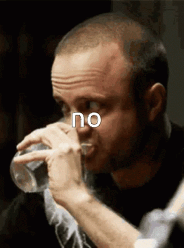 A Man Drinking A Glass Of Water With The Word No Above His Face GIF