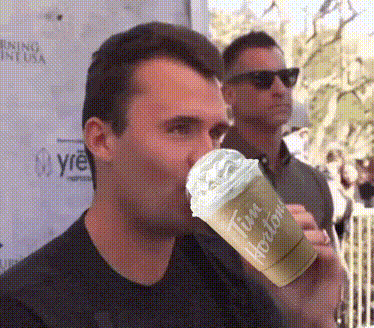 A Man Drinking A Tim Hortons Drink With Whipped Cream GIF