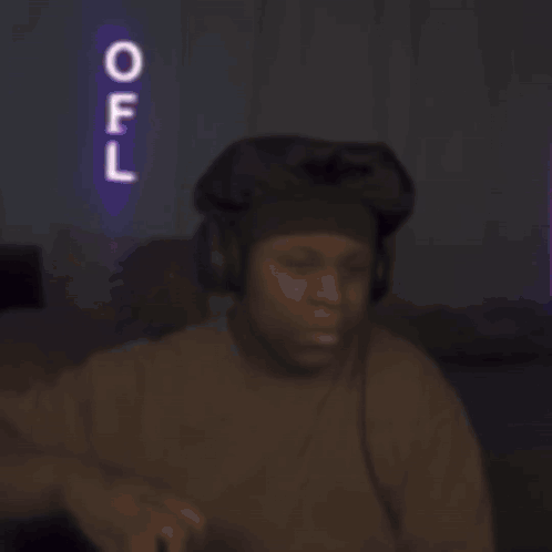 a man drinking from a bottle with a neon sign that says off in the background