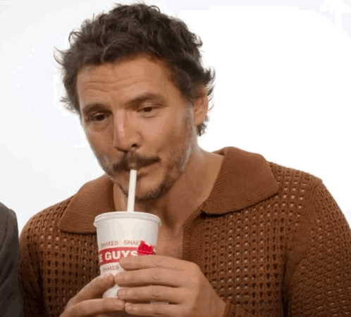 A Man Drinking From A Cup That Says Guys GIF