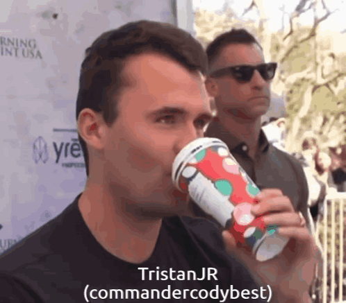 A Man Drinking From A Cup With The Name Tristan Jr Written On It GIF