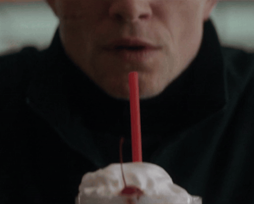 A Man Drinks A Milkshake With A Cherry On Top GIF