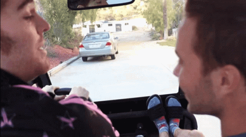A Man Driving A Car With A License Plate That Says ' Lgc ' On It GIF