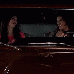 A Man Driving A Car With A Woman Sitting In The Back Seat GIF