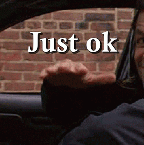 A Man Driving A Car With Just Ok Written On The Window GIF