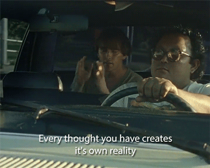 A Man Driving A Car With The Words " Every Thought You Have Creates It 'S Own Reality " Written On The Windshield GIF