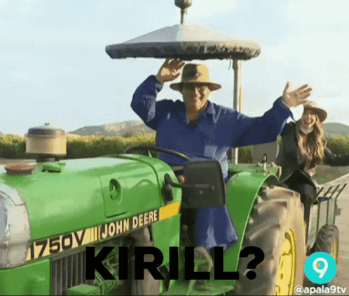 A Man Driving A John Deere Tractor With The Words " Kirill " On The Front GIF