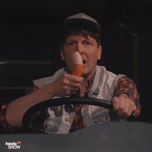 A Man Driving A Vehicle With The Words Heute Show On The Bottom Left GIF