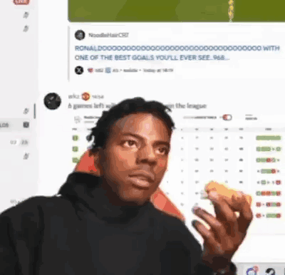 A Man Eating A Sandwich In Front Of A Computer Screen . GIF