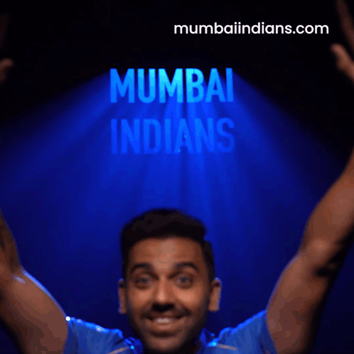 A Man Flexes His Muscles In Front Of A Mumbai Indians Logo GIF