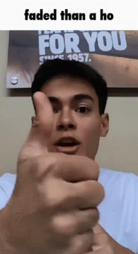 A Man Giving A Thumbs Up In Front Of A Poster That Says For You GIF