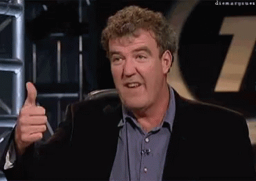 A Man Giving A Thumbs Up In Front Of A Sign That Says 7 GIF