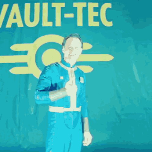 A Man Giving A Thumbs Up In Front Of A Sign That Says Vault-C GIF
