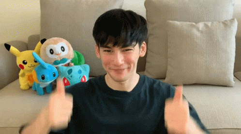 A Man Giving A Thumbs Up In Front Of Stuffed Pokemon GIF