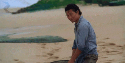A Man Giving A Thumbs Up On A Beach GIF