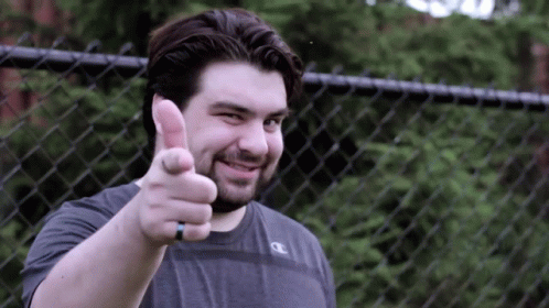 A Man Giving A Thumbs Up With A Champion Shirt On GIF