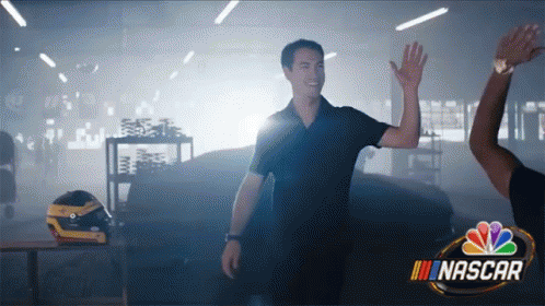 A Man Giving Another Man A High Five In A Nascar Ad GIF