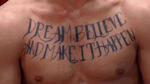 A Man Has A Tattoo On His Chest That Reads " Dream Believe And Make It Happen " GIF