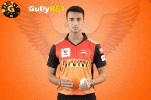 A Man Holding A Ball In Front Of Gullybet GIF