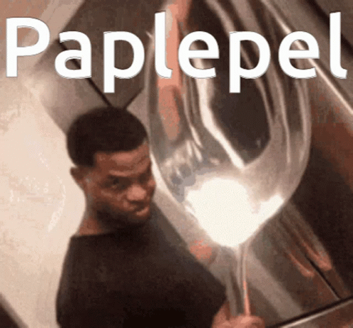 A Man Holding A Balloon With The Word Paplepel Written On It GIF