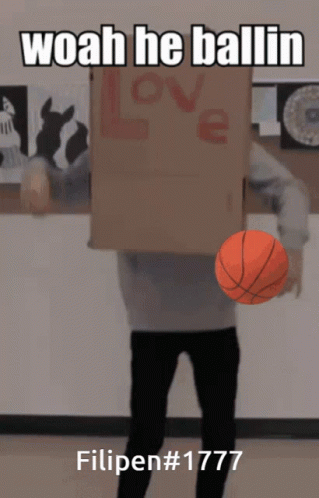 a man holding a basketball in front of a cardboard box that says love