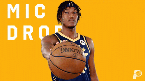 A Man Holding A Basketball In Front Of A Yellow Background That Says " Mic Drop " GIF