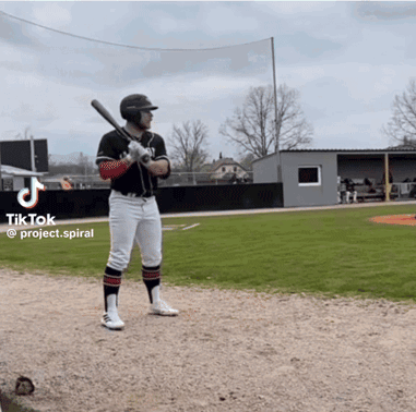 A Man Holding A Bat On A Baseball Field With A Tiktok Logo On The Bottom GIF