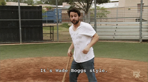 A Man Holding A Bat With The Words It 'S Wade Boggs Style Below Him GIF