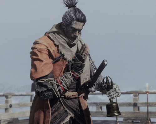 A Man Holding A Bell And A Sword In His Hands GIF