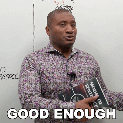 A Man Holding A Book That Says " Good Enough " On It GIF