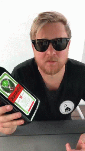 A Man Holding A Bottle Of Jagermeister 50 GIF