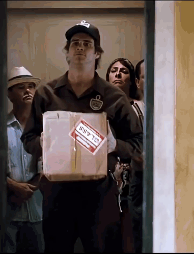 A Man Holding A Box With A Label That Says Ssfts GIF