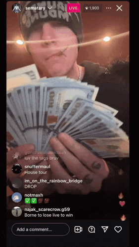 A Man Holding A Bunch Of Money In Front Of A Screen That Says Sematary GIF