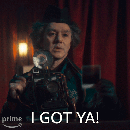 A Man Holding A Camera With The Words I Got Ya On The Bottom Right GIF
